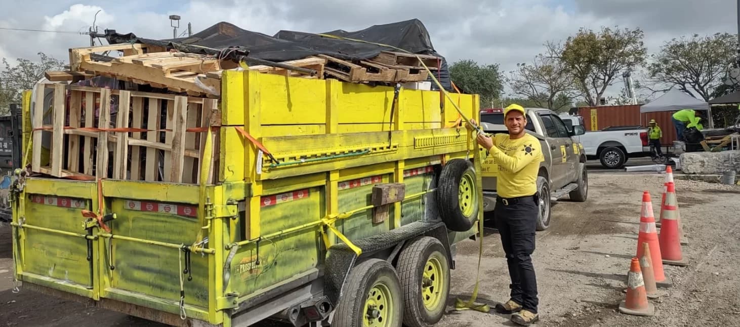 Sunshine Demolition crew loading a trailer with debris in Broward County